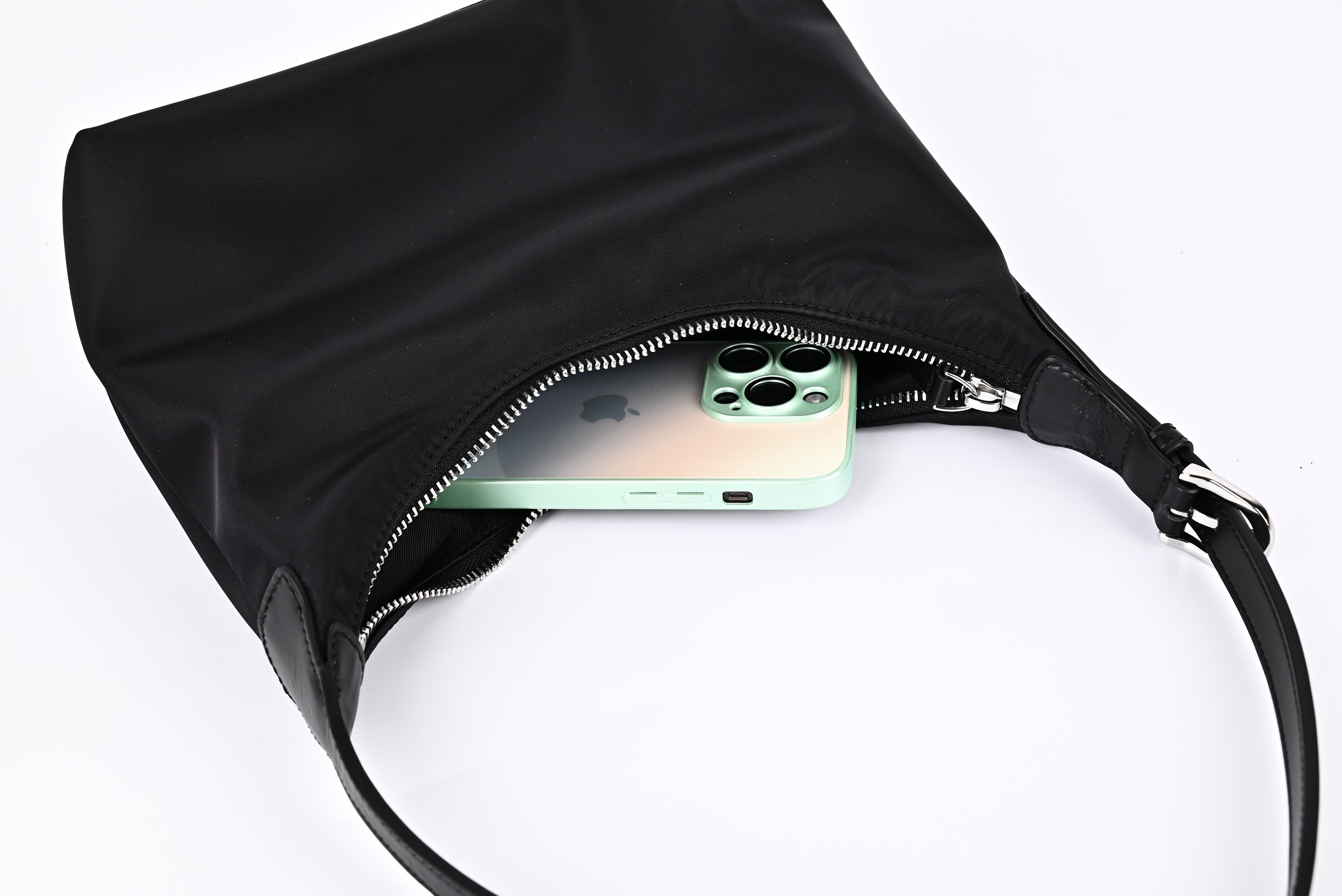 Black nylon hobo shoulder bag capacity demonstration with iPhone inside, showing large storage space"
"Practical black nylon hobo bag with roomy interior that easily fits phone and daily essentials