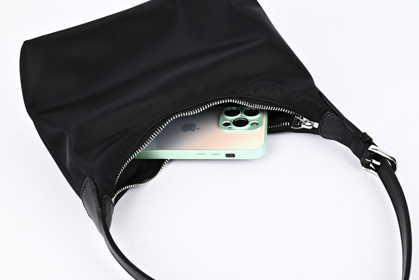 Black nylon hobo shoulder bag capacity demonstration with iPhone inside, showing large storage space"
"Practical black nylon hobo bag with roomy interior that easily fits phone and daily essentials