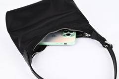 Black nylon hobo shoulder bag capacity demonstration with iPhone inside, showing large storage space"
"Practical black nylon hobo bag with roomy interior that easily fits phone and daily essentials