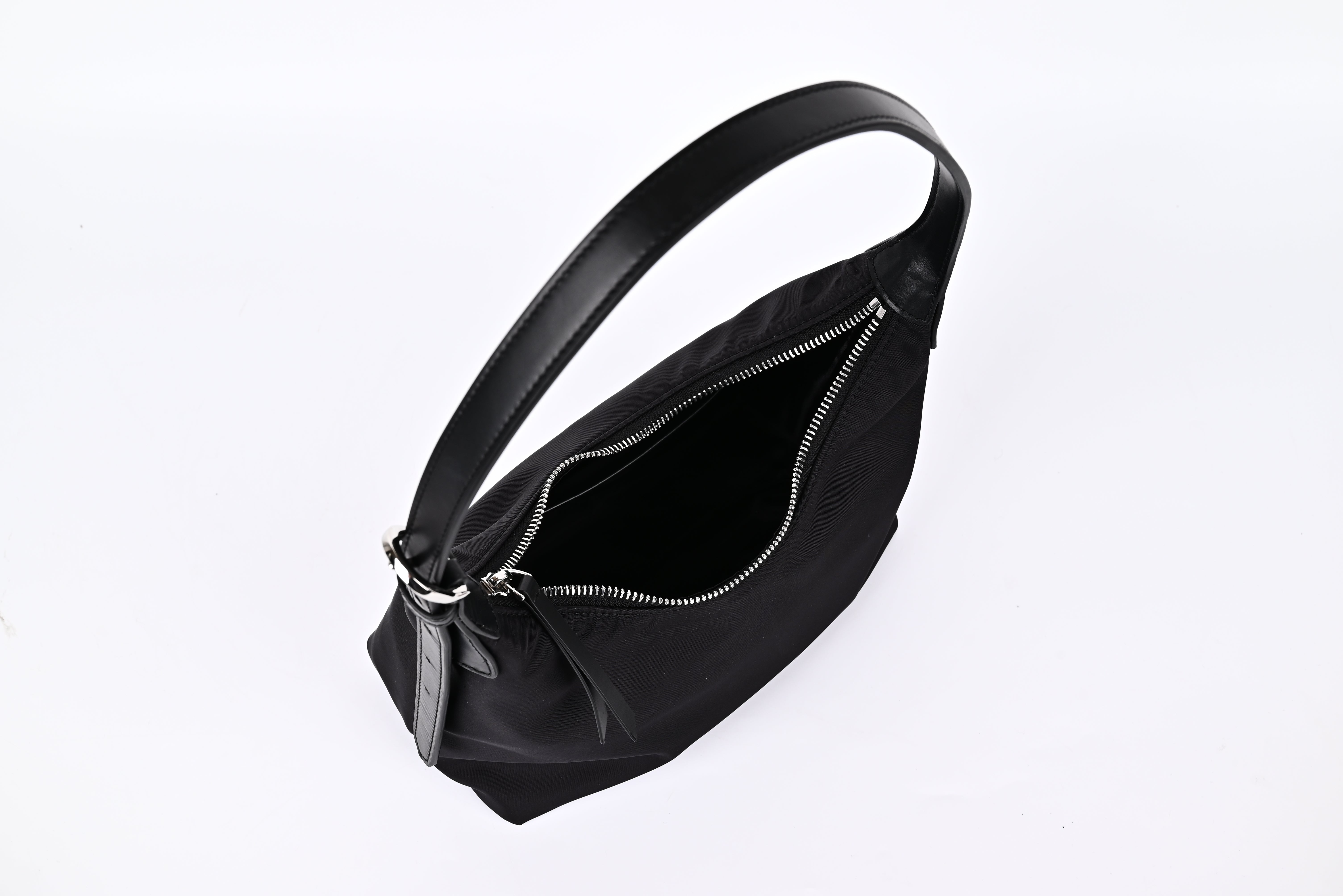 Black nylon hobo shoulder bag open view showing spacious interior and smooth zipper detail"
"Prada-inspired black nylon hobo bag interior with generous storage space and quality zipper