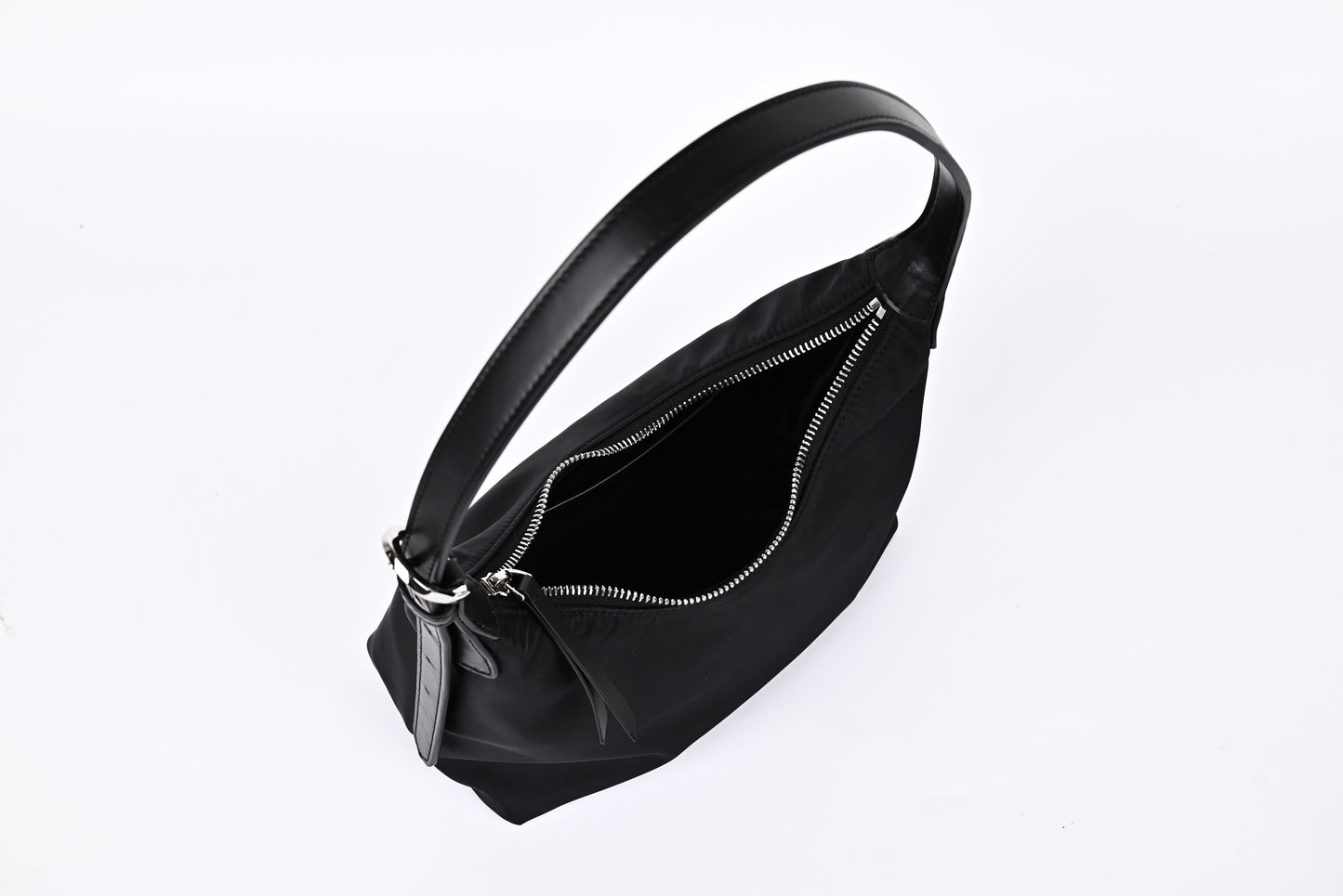 Black nylon hobo shoulder bag open view showing spacious interior and smooth zipper detail"
"Prada-inspired black nylon hobo bag interior with generous storage space and quality zipper