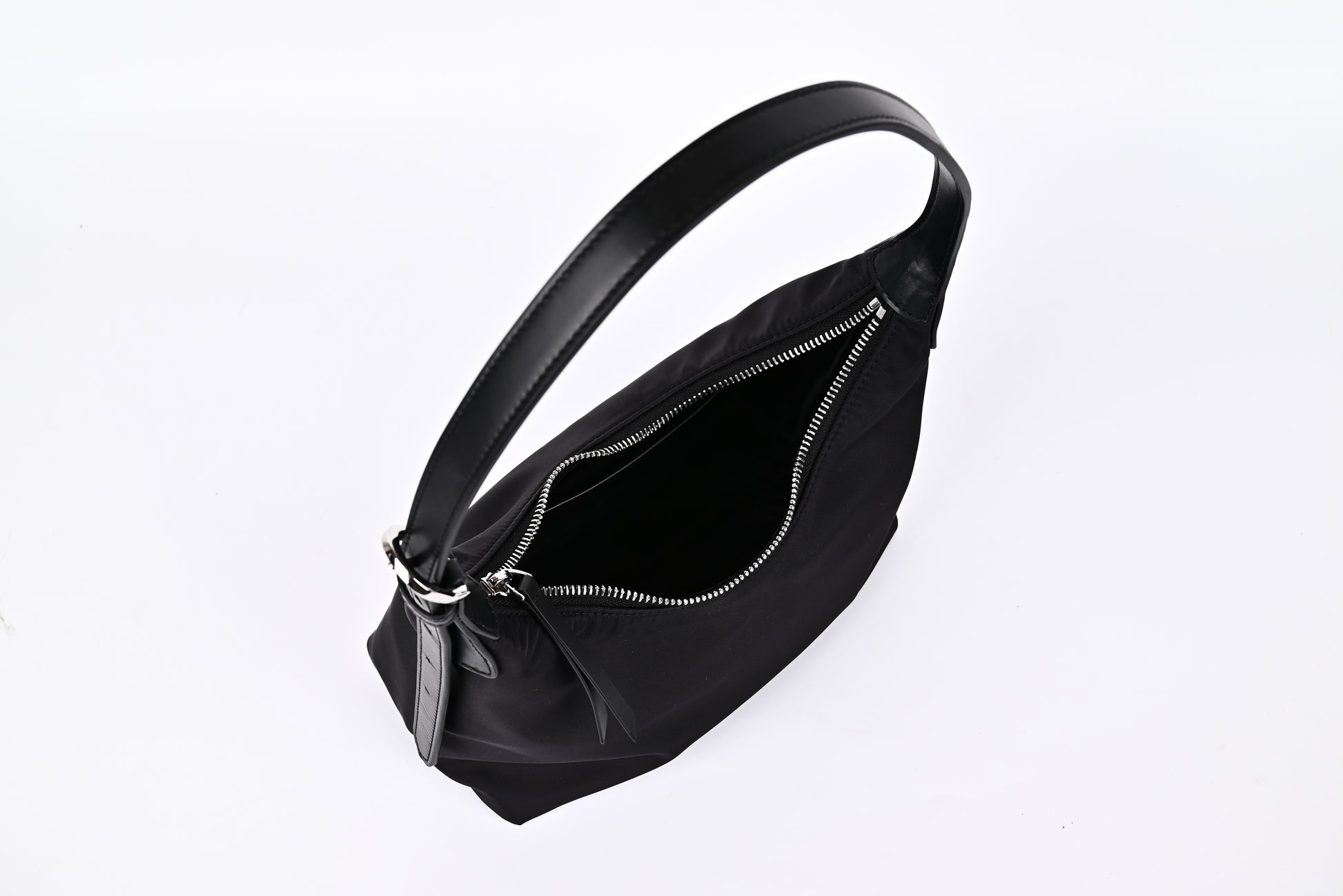 Black nylon hobo shoulder bag open view showing spacious interior and smooth zipper detail"
"Prada-inspired black nylon hobo bag interior with generous storage space and quality zipper