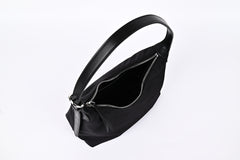 Black nylon hobo shoulder bag open view showing spacious interior and smooth zipper detail"
"Prada-inspired black nylon hobo bag interior with generous storage space and quality zipper