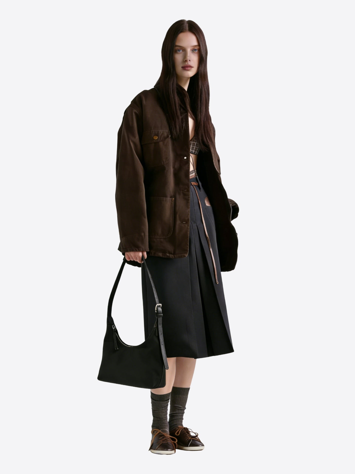 Black nylon hobo shoulder bag worn on shoulder by model, showing natural drape and daily commuter style"
"Prada-style black nylon hobo bag on model for everyday wear and casual luxury look