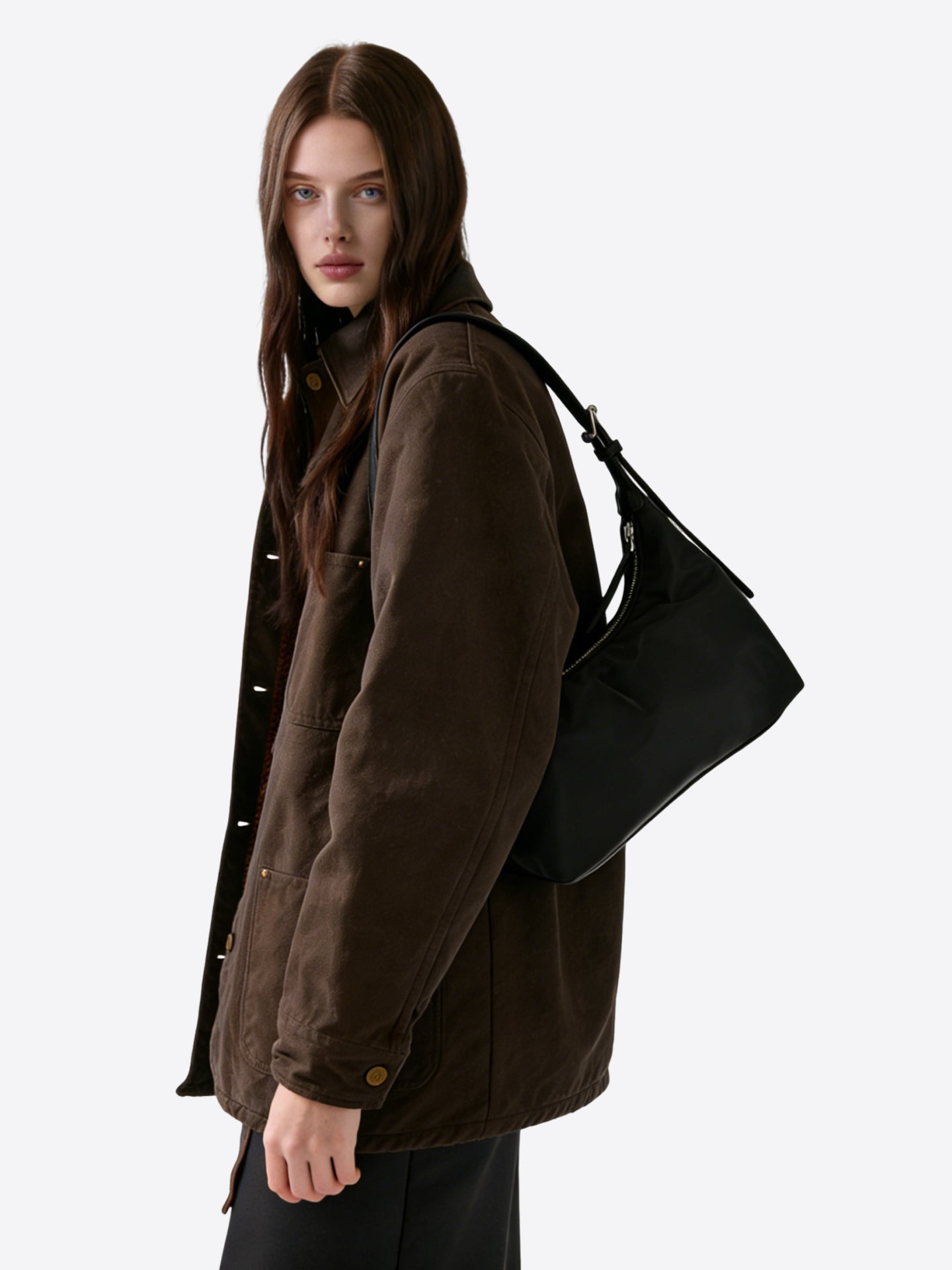 Black nylon hobo shoulder bag worn on shoulder by model, showing natural drape and daily commuter style"
"Prada-style black nylon hobo bag on model for everyday wear and casual luxury look